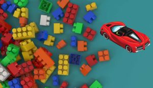 Illustrazione di alcuni mattoncini e di una Ferrari (Canva FOTO) - managementcue.it